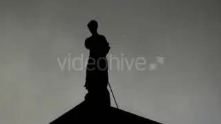 Artemida Looking Statue on a Roof in the Evening With Flying Birds Around