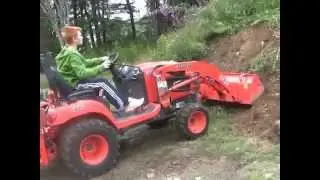 Max learning to use backhoe and FEL Kubota BX25