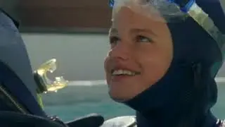A female diver in wetsuit remains trapped underwater. Air is running out!