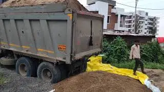 Truck dumping 1200 cubic feet of sand