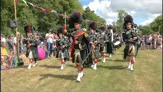 Lonach Pipe Band march on to start displays during 2023 Drumtochty Highland Games in Scotland