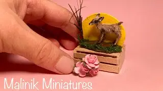 Miniature moving polymer clay deer scene