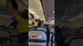 Cebu Pacific cabin crew assisting passenger on his bag 