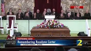 The Carter family escorts former President Jimmy Carter into funeral service for Rosalynn Carter