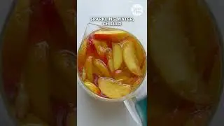 Our peach sangria recipe is like sunshine in a glass! #peachsangria