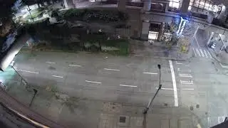 Man tossing bottle over foot bridge without regards to traffic below