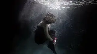 Underwater video shooting. A couple in love like in a fairy tale