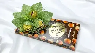 Diy decor of a chocolate bar with candy nuts and crepe paper. DIY mini present.