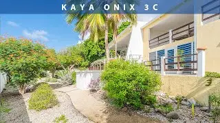 There is a beautiful house in this tropical garden with exotic animals