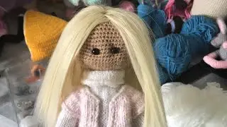 Everyday life of knitters. Sewing tresses to a doll. Knitting