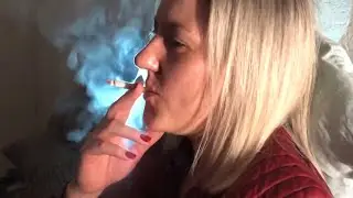 Experienced smoker smokes a cork cigarette