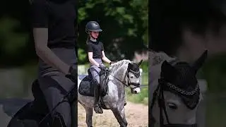 Little girl riding her dressage pony