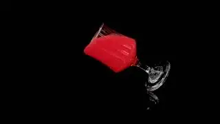 Wine glass dropping to the flow in slow motion