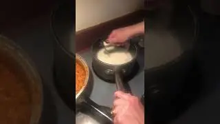 Stirring béchamel sauce with a whisk