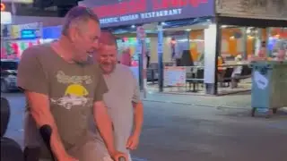 Tipsy friends end up on the ground laughing after a misjudged air-punch || WooGlobe