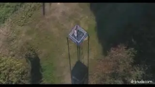 Maya nude on the watch tower, as seen by a drone