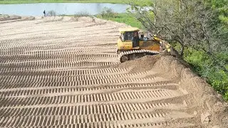best project and smooth operator bulldozer filling up sand to the big lake lot of dump truck!