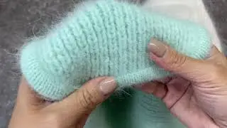 Kettle stitching a hat with earflaps