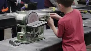 Scouts work on Pinewood Derby cars at Steve’s Auto Repair