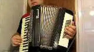Ahmet Akarsu playing the accordion at home