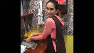 Gorgeous Thai transgender woman at home doing house work and talking to her audience