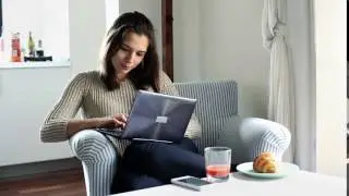 woman sit in armchair and typing on modern laptop at home ejygg5vxg  D