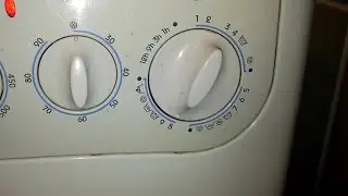 The Indesit washing machine's programmer knob spins in a circle.