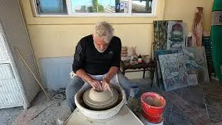 Opening clay on the pottery wheel