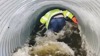 Unclogging Culvert To Drain Roadway