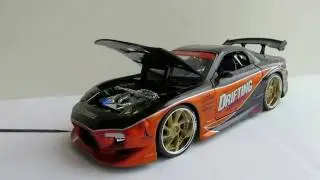 #01 Mazda RX - 7 1/24 Видеообзор модели от Jada Toys