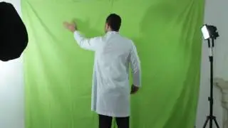 Doctor man wearing white robe against green screen performing touch screen gestures. Stock footage