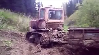 Tracked tractor trying hill climb after rain