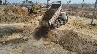 Deep Pond Pouring Soil Dump Truck And Clear By Bulldozer To Widening Long Canal Construction