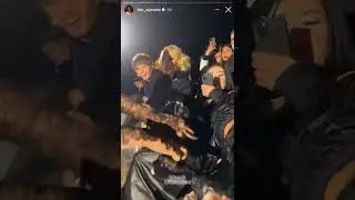 Arca snatches purse from JT at the Mugler Fashion Show. 