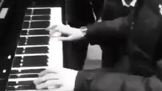 Louis Partridge playing the piano
