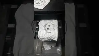 Screen Printed Bare Assets Shirts going thru conveyor Dryer
