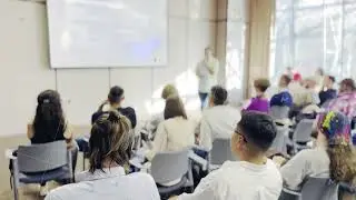 Business presentation with diverse audience listening attentively in conference room