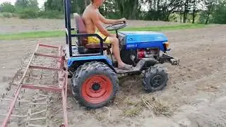 Harrowing with a minitractor AMZK-8