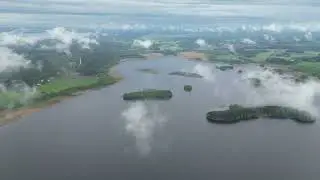 Drone flight over cloudy lake Sysmäjärvi near town Outokumpu, Eastern Finland 25.5.23