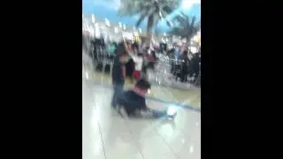 A girl  biting a boy