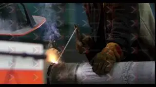 A welder is welding two metal workpieces