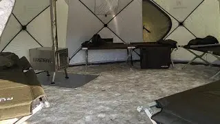 Folding beds and a stove-fireplace are located in the RUSTRAIL Yurta 420 tent.