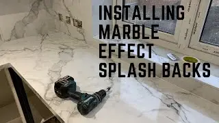 Installing marble effect splash backs.