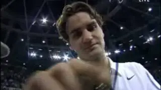 Roger Federer signs on the camera. Smile!
