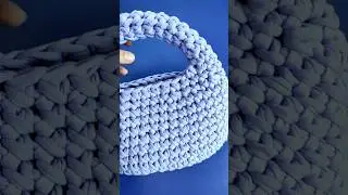 A custom crochet bag made from lavender knitted yarn. 