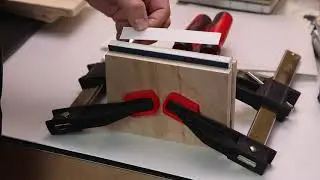 Sawing sewing holes in book spine.