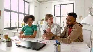 Man Showing Smartphone To Coworkers at Office 84 | Videohive Project Templates