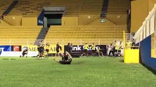 Diego Maradona and his Dorados players belly-sliding through puddles.
