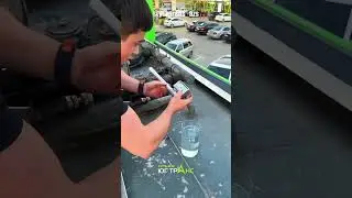 Gas station employee measures gasoline and shows the octane rating delivered to the station.