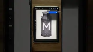 Blending a letter with a surface in Procreate.